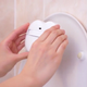 Illustration for article titled This Stick-On Robotic Arm Promises to Put the Damn Toilet Seat Down For You